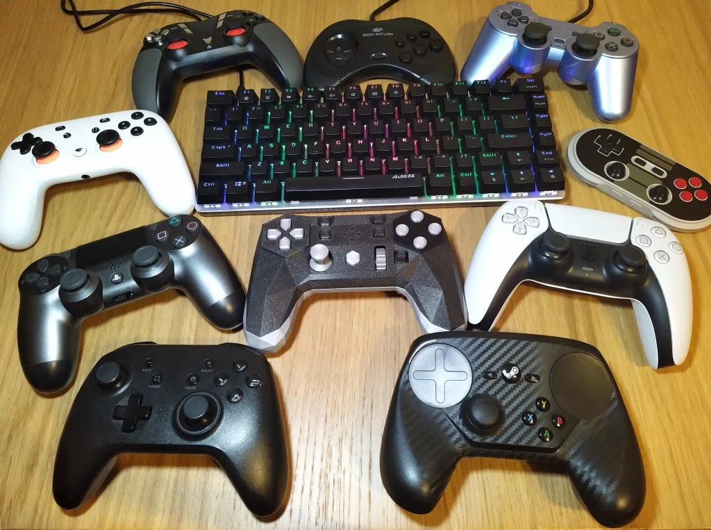 Collection of controllers with an 80% keyboard in the middle and the Alpakka controller right below it.