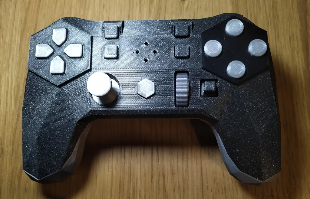 Picture of Alpakka controller showing all nine face buttons, directional pad, left analog stick, scroll wheel, and clicky directional joystick.